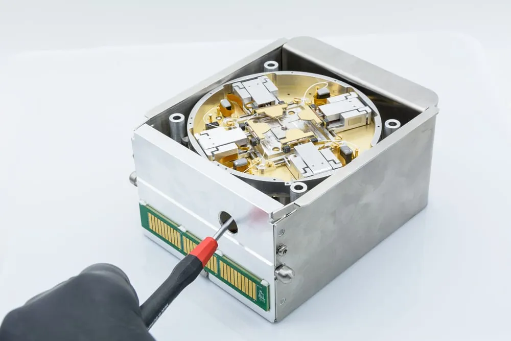 The Prober Shuttle closed, viewed from above, showing its stainless-steel lid with a circular sample-access window and edge connector.