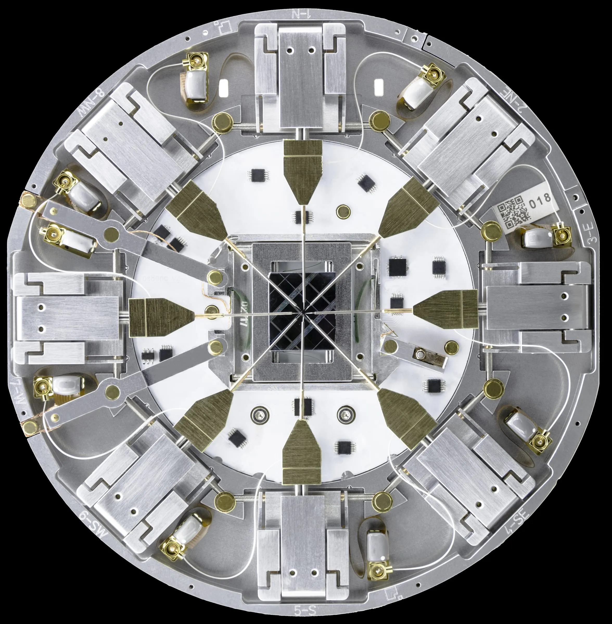 Top-down view of the PS8e Prober Shuttle, eight MM4 manipulators converging on a central chip.