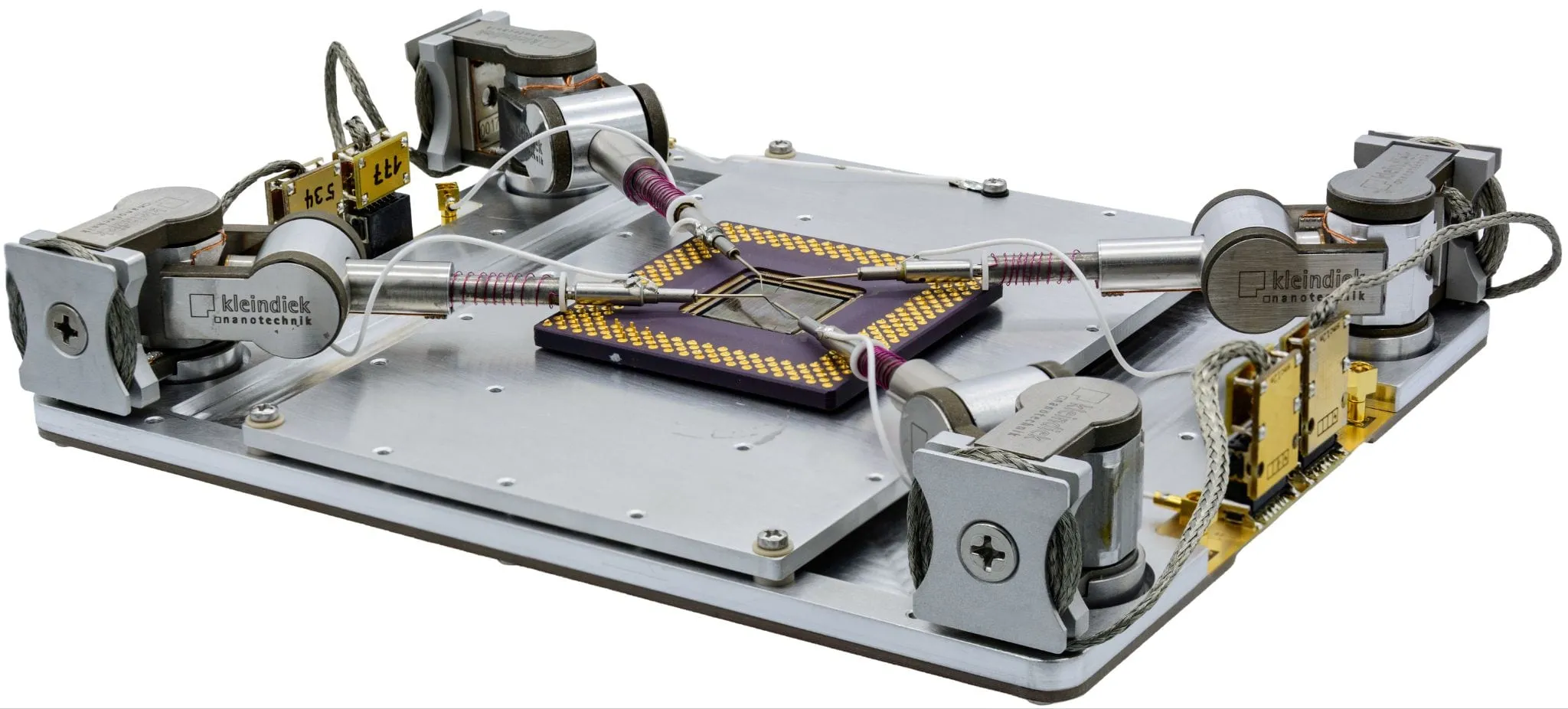 The NW4 platform — a load-lock-compatible base with space for up to four MM3A-EM micromanipulators arranged around a large substrate.
